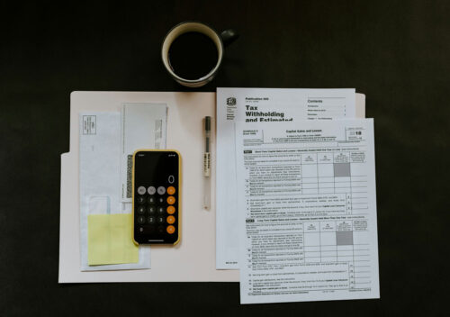 Tax papers and IRS forms, calculator and files